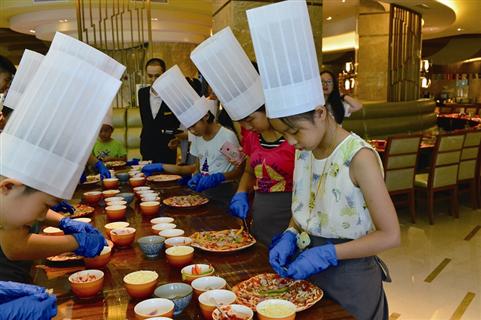 10个"帖粉"家庭在希尔顿逸林酒店西餐厅厨师长王宇祥的指导下,动手