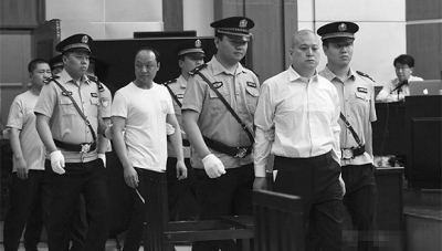 1.王文军(前右二)被带上法庭。