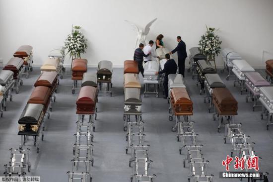 当地时间2016年12月1日,哥伦比亚麦德林,遭遇空难的巴西沙佩科恩斯球员的亲友在棺材前哀悼逝者。