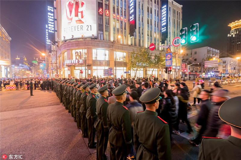 2016年12月31日,上海,南京路步行街、外滩迎来跨年大客流观光人流,上海交警全员上岗协同武警维持重点区域秩序,在南京东路河南路执勤武警采取拉链式间歇放行,确保观光人流安全有序通行。