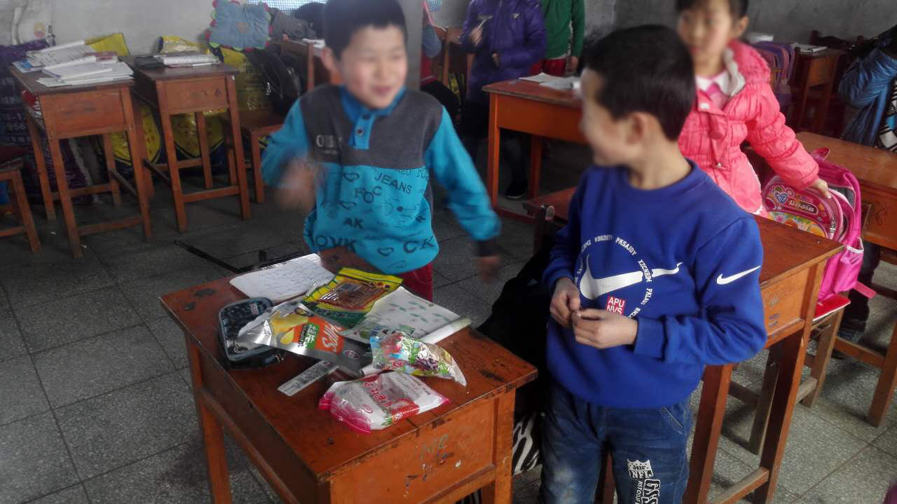 某小学的学生正在课件分享山寨小零食。一位“免费午餐”公益团队志愿者说:“那天看我女儿同学在吃五毛一包的辣条,一股特别诱人的奇香,因为全是过量的香精色素添加剂 。”