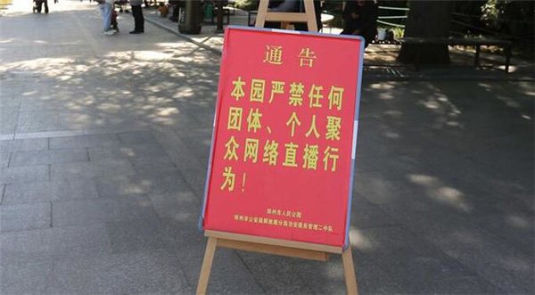 在公园莲花池小广场,除了几个练字、聊天的老人,只有园内清洁工在打扫卫生,池内小广场上,空空如也。