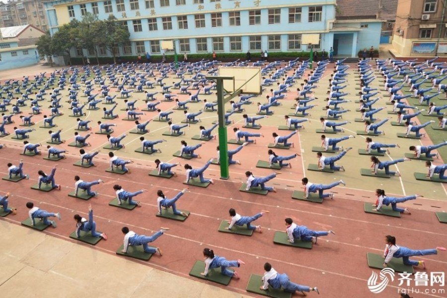 据明珠小学德育主任王傲铌介绍，学校管理人员一直都有开发体操作为课间操的想法，“最初是学校体育老师邹梅上了一节展示课，课上全班学生都能完成横叉、仰卧推起成桥等动作，我们就想，可不可以推及到全校呢？经过反复研讨，学校的体育老师和艺术老师一起创编了这套素质操，在体育课上教给学生，等孩子们逐渐学会并适应后，便开始作为了课间操的内容”。因为一二年级的学生身体发育还不够成熟，“只让他们练习单一动作，但三至五年级学生要完成整套素质操”。图为学生们在做课间操。 （齐鲁网记者 张煜晴 韩莹 实习记者 马金龙 通讯员 张春蕾）