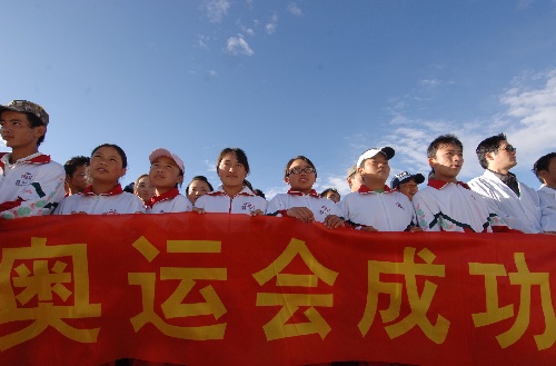 西藏教育界学生代表拿着"奥运会成功"的横幅参加健步走活动.