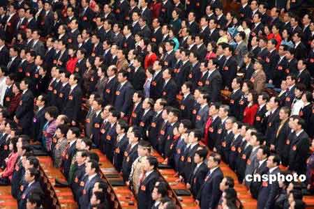 3月18日上午，十一届全国人大一次会议在北京人民大会堂闭幕，全体代表起立，高唱国歌。中新社发 张宇 摄