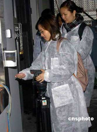 四月一日，香港沙田奥运马术比赛场地工程大致完成，并首次开放予传媒采访。图为进出马房的人士都要穿上保护衣，并要用洗手液消毒。中新社发谭达明 摄