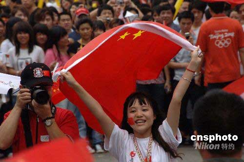 市民舞动国旗喜迎圣火  图片来源：中国新闻网