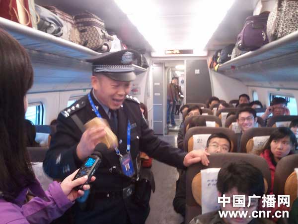 乘警史恩礼在车厢中为乘客做安全提示