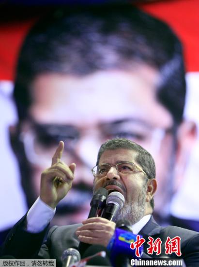 6月24日，埃及最高总统选举委员会宣布，穆斯林兄弟会下属自由与正义党主席穆尔西赢得穆巴拉克下台后的首次埃及民主总统大选。图为2012年4月30日在开罗拍摄的穆尔西的资料照片。