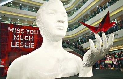 香港“继续宠爱・十年・纪念展”上，张国荣雕像手捧红色纸鹤。