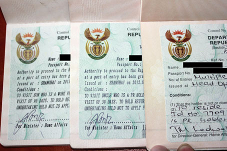 左边两个为移民局今年6月份以后发出的签证纸，右边为之前发出的签证纸，颜色上有很大的差异。（南非《华侨新闻报》）