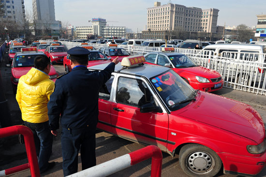 在火車站出站口出租車候車處,太原市客運辦工作人員安排等候乘車的