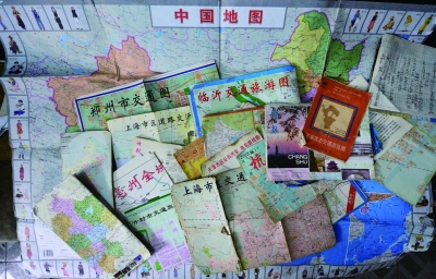 郭刚堂走遍了数十个省份，这只是他用过的部分地图 摄/法制晚报记者 郭谦